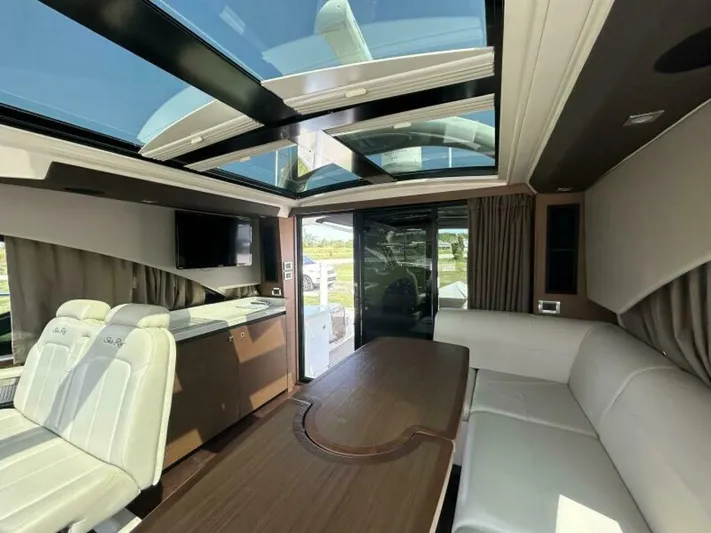  Yacht Photos Pics Luxurious interior of 2014 Sea Ray 510 Sundancer yacht with skylight and modern seating.