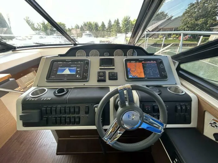  Yacht Photos Pics Helm of 2014 Sea Ray 510 Sundancer with dual navigation screens and modern controls.