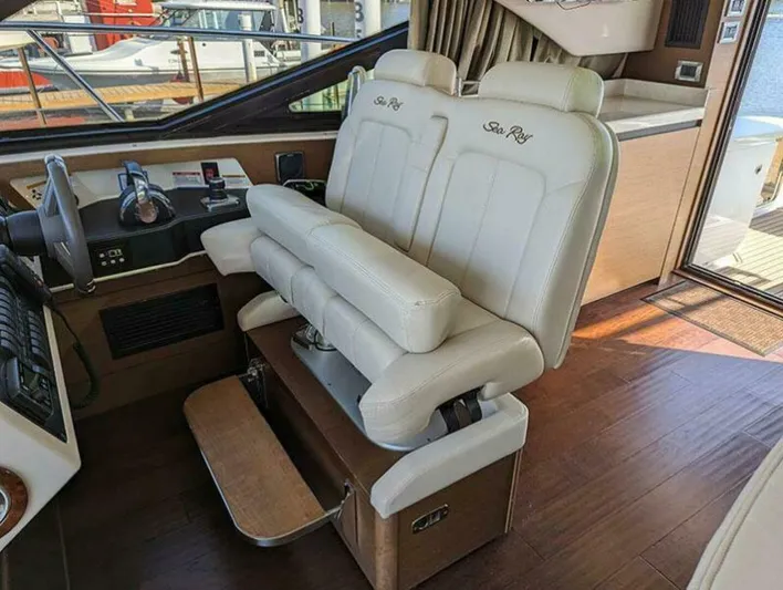  Yacht Photos Pics 2014 Sea Ray 510 Sundancer helm with dual white leather seats and wooden flooring.
