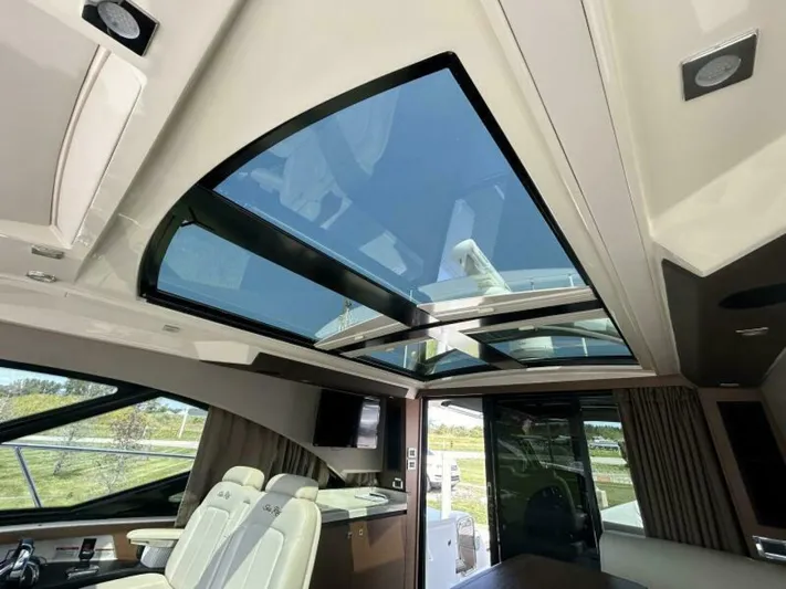  Yacht Photos Pics Interior view of 2014 Sea Ray 510 Sundancer yacht with panoramic sunroof and luxurious seating.