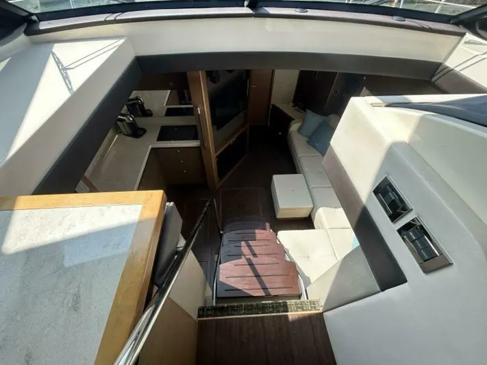  Yacht Photos Pics Interior of 2014 Sea Ray 510 Sundancer yacht with modern seating and kitchenette.