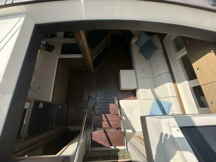  Yacht Photos Pics Interior view of 2014 Sea Ray 510 Sundancer yacht, featuring elegant seating and wooden flooring.