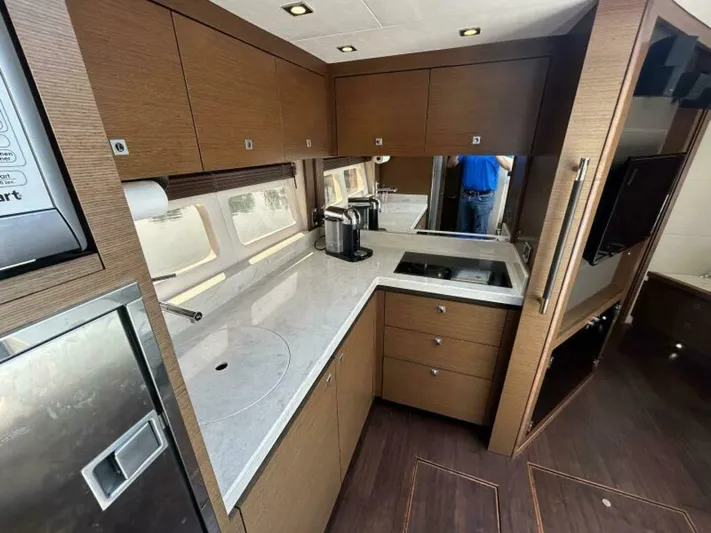  Yacht Photos Pics Luxurious kitchen interior of 2014 Sea Ray 510 Sundancer yacht with modern appliances and sleek design.