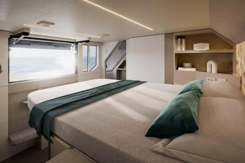  Yacht Photos Pics Luxurious bedroom interior of 2026 Absolute Navetta 66 yacht with ocean view.