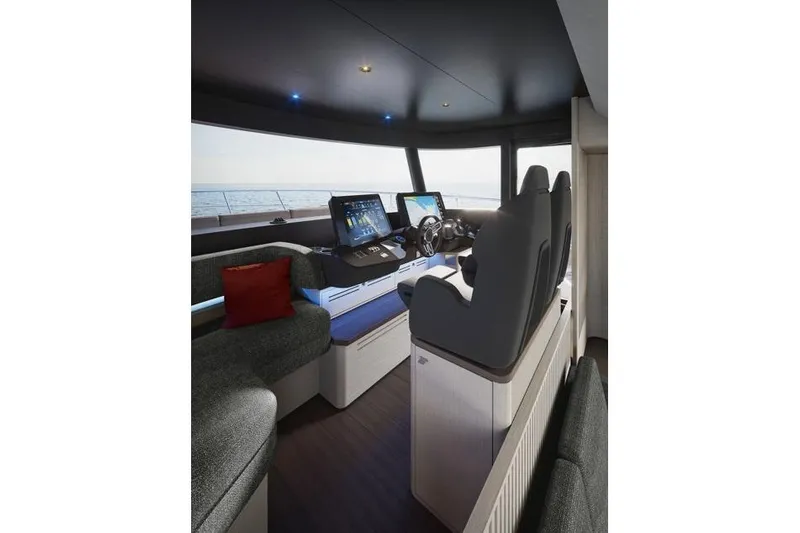  Yacht Photos Pics Interior of 2026 Absolute Navetta 66 yacht with modern helm and seating.