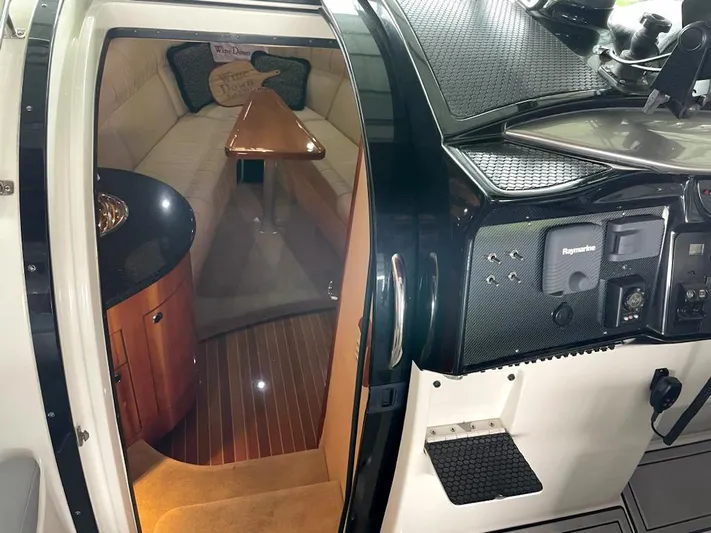 New Engines 2021 Yacht Photos Pics Interior of a 2005 Cobalt 360 boat, featuring a cozy cabin and modern dashboard.