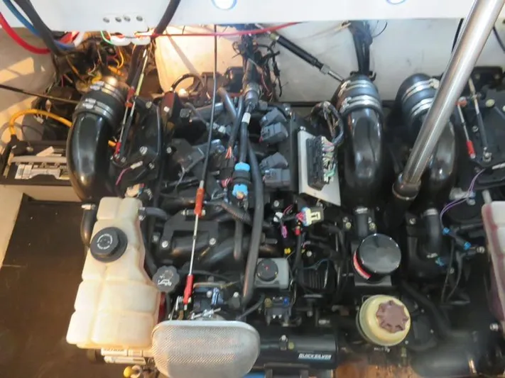 New Engines 2021 Yacht Photos Pics Engine compartment of a 2005 Cobalt 360 boat, showcasing complex wiring and components.