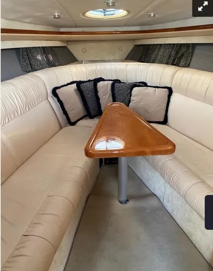 New Engines 2021 Yacht Photos Pics Luxurious interior of a 2005 Cobalt 360 boat with plush seating and elegant wooden table.