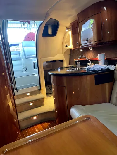 New Engines 2021 Yacht Photos Pics Luxurious interior of a 2005 Cobalt 360 yacht with wood finishes and kitchenette.