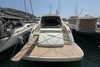 Astondoa 53 Open 2007 yacht docked at marina, rear view with wooden deck.