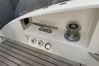 Astondoa 53 Open 2007 yacht deck with cleat and winch, featuring teak flooring.