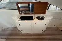 Compact kitchenette on 2007 Astondoa 53 Open yacht with stove and sink.