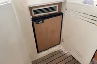 Mini fridge on 2007 Astondoa 53 Open yacht with wooden paneling.