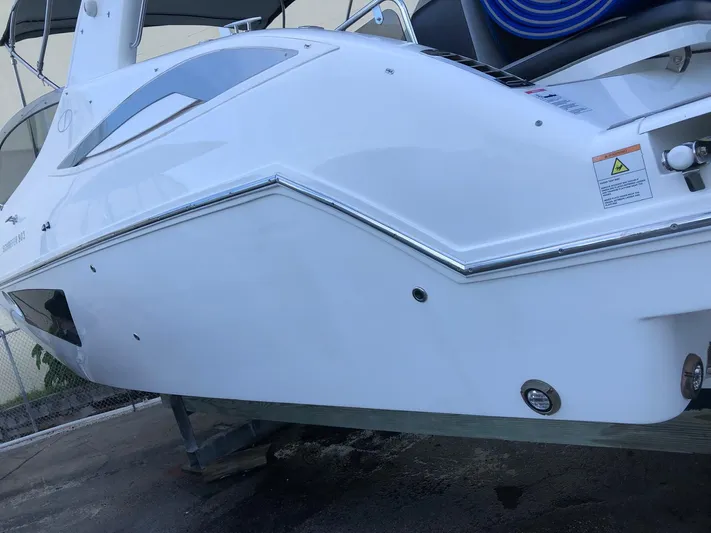  Yacht Photos Pics Schaefer 303 boat, 2021 model, sleek white exterior, docked on a stand.