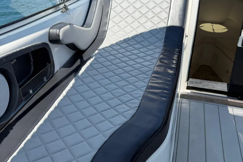  Yacht Photos Pics Luxurious seating on 2021 Schaefer 303 boat, featuring quilted upholstery and sleek design.