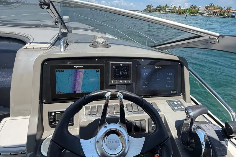  Yacht Photos Pics Cockpit view of 2021 Schaefer 303 boat with navigation screens and steering wheel.