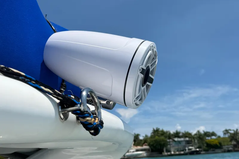  Yacht Photos Pics White speaker on a Schaefer 303 boat, 2021 model, with blue sky background.