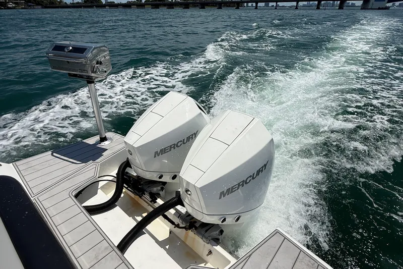  Yacht Photos Pics Schaefer 303 boat with dual Mercury outboard engines cruising on water, 2021 model.