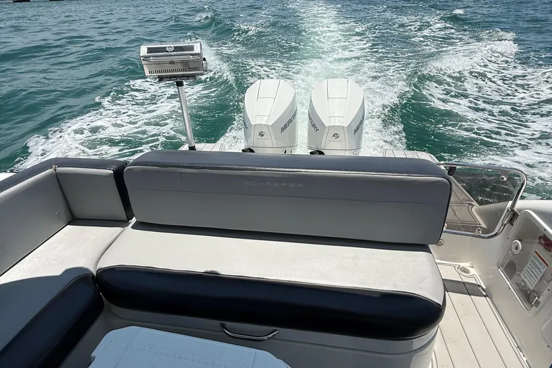  Yacht Photos Pics Schaefer 303 boat interior with twin Mercury engines, cruising on open water, 2021 model.