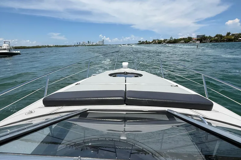  Yacht Photos Pics Schaefer 303 yacht cruising on open water, 2021 model, sunny day, city skyline in background.