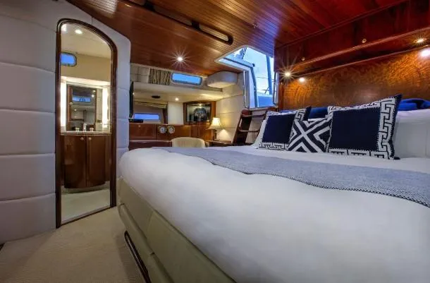 Sorcerer II Yacht Photos Pics Luxurious cabin interior of 1998 Cookson Frers yacht with elegant bedding and wood accents.