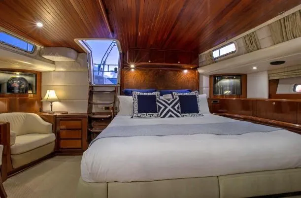 Sorcerer II Yacht Photos Pics Luxurious 1998 Cookson Frers yacht cabin with elegant wood paneling and cozy bedding.