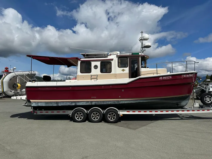  Yacht Photos Pics 2014 Ranger Tugs R-31S boat on trailer under cloudy sky.
