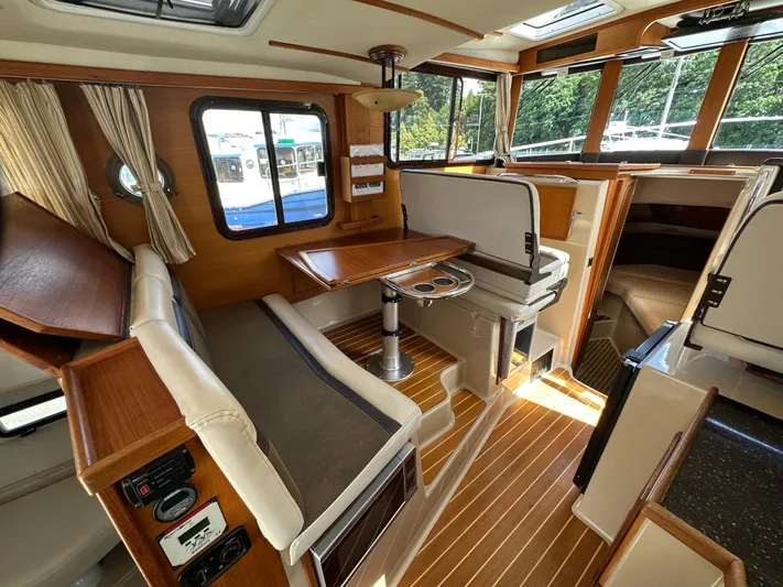  Yacht Photos Pics 2014 Ranger Tugs R-31S interior with wood accents, seating, and dining table.