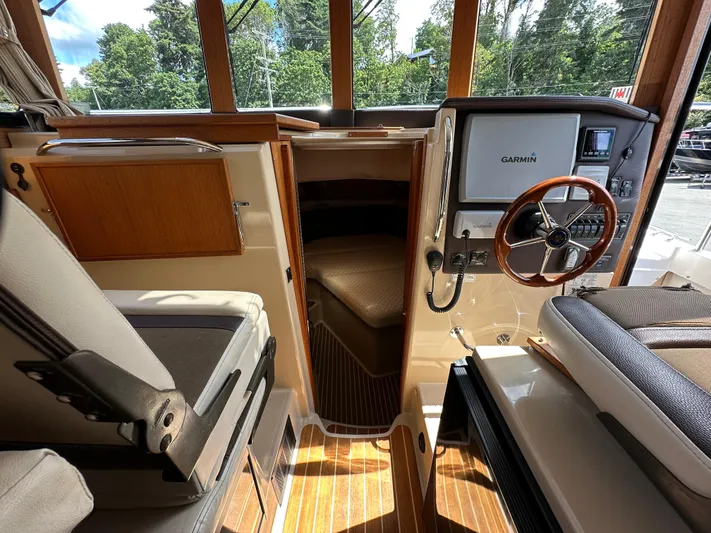  Yacht Photos Pics Interior of 2014 Ranger Tugs R-31S boat with steering wheel and Garmin navigation system.