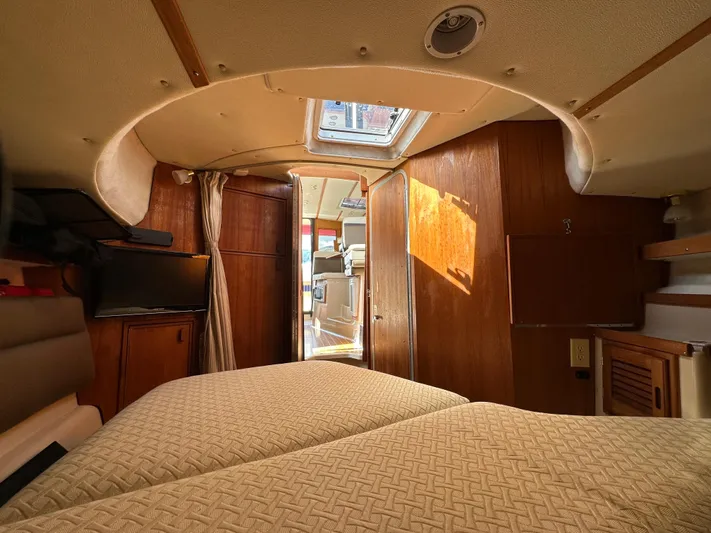  Yacht Photos Pics 2014 Ranger Tugs R-31S interior cabin with cozy bedding and wooden finishes.