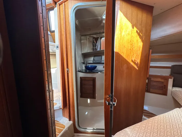  Yacht Photos Pics 2014 Ranger Tugs R-31S interior cabin with wooden door and cozy sleeping area.