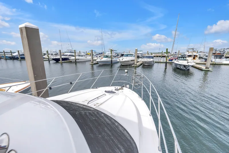  Yacht Photos Pics 2007 Meridian 459 Motoryacht docked in a marina with other boats under a clear blue sky.
