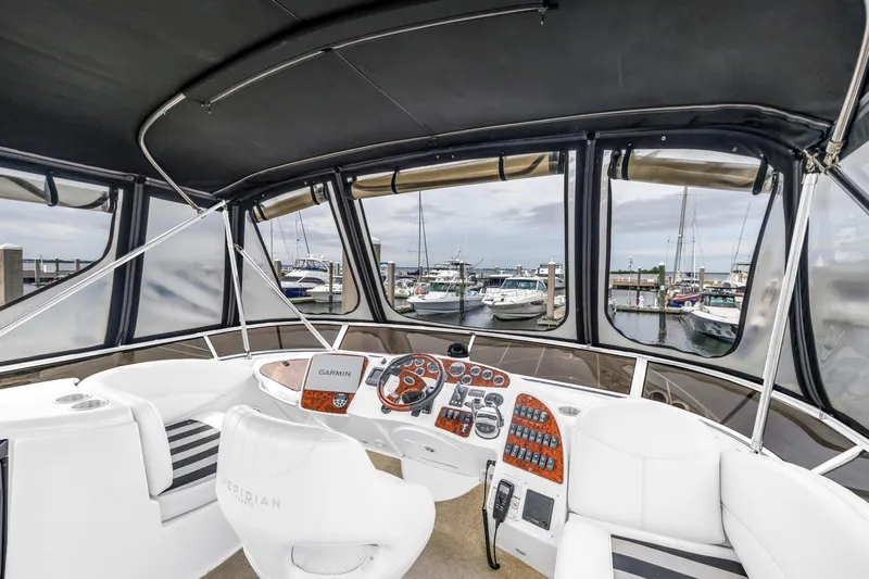  Yacht Photos Pics 2007 Meridian 459 Motoryacht helm with marina view, featuring modern navigation equipment.