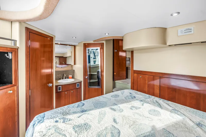  Yacht Photos Pics Luxurious interior of 2007 Meridian 459 Motoryacht with wood finishes and cozy bedding.