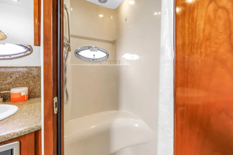  Yacht Photos Pics Shower area in 2007 Meridian 459 Motoryacht with porthole and granite countertop.
