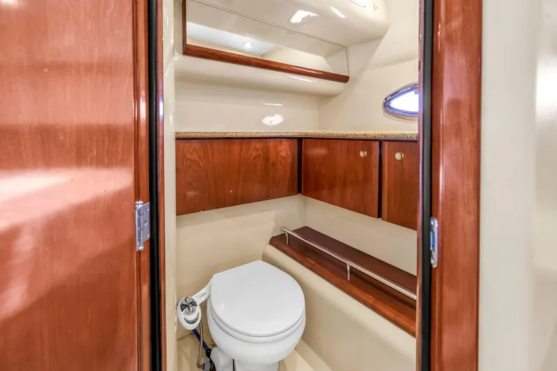  Yacht Photos Pics 2007 Meridian 459 Motoryacht bathroom with wooden cabinets and compact toilet.