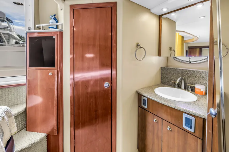  Yacht Photos Pics 2007 Meridian 459 Motoryacht bathroom with wooden cabinetry and granite countertop.