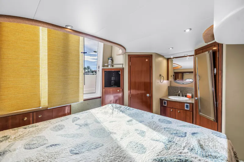  Yacht Photos Pics Luxurious interior of 2007 Meridian 459 Motoryacht with cozy bedroom and elegant wood finishes.