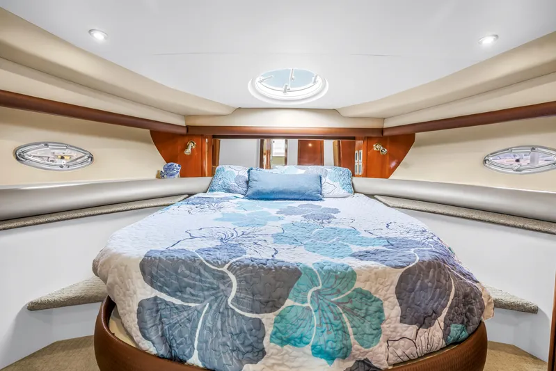  Yacht Photos Pics Luxurious bedroom interior of 2007 Meridian 459 Motoryacht with floral bedding and porthole windows.