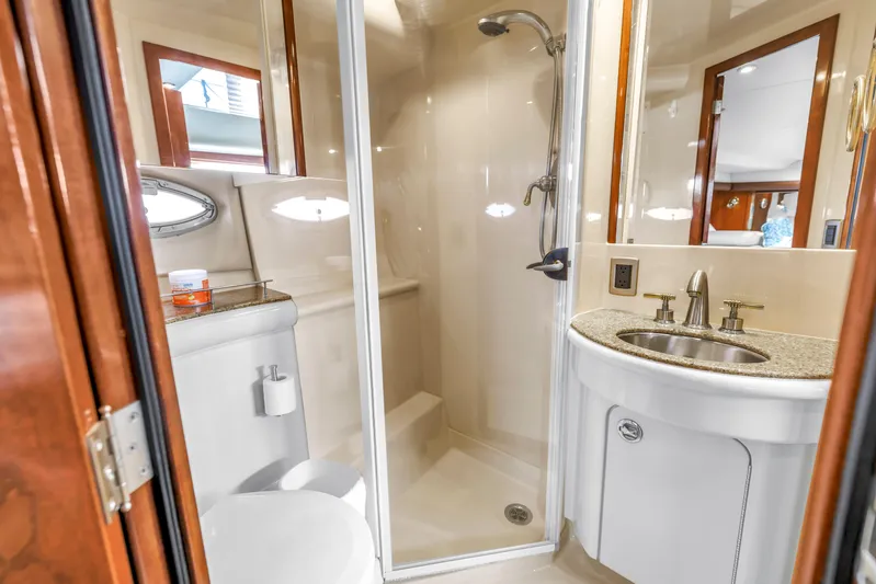  Yacht Photos Pics Luxurious bathroom in 2007 Meridian 459 Motoryacht with shower, sink, and toilet.