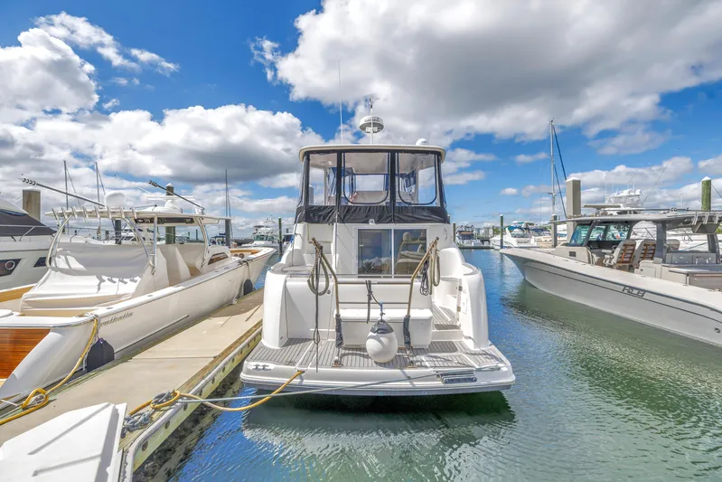  Yacht Photos Pics 2008 Meridian 459 Motoryacht docked at marina under blue sky and clouds.