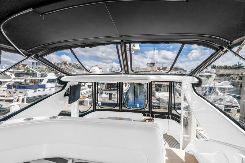 Yacht Photos Pics 2008 Meridian 459 Motoryacht interior view at marina, showcasing helm and surrounding boats.