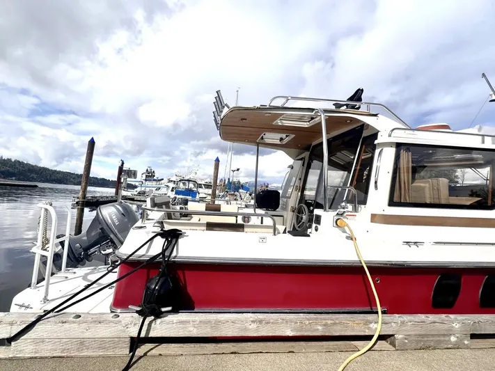  Yacht Photos Pics 2015 Ranger Tugs R-29S docked at marina under cloudy sky.