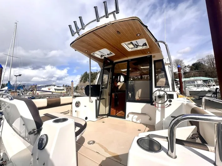  Yacht Photos Pics 2015 Ranger Tugs R-29S boat with open deck and cabin, docked at marina.
