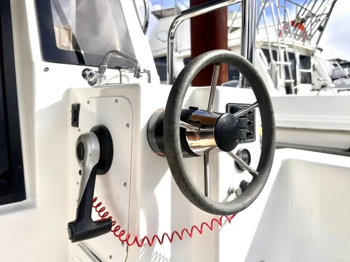  Yacht Photos Pics Steering wheel of 2015 Ranger Tugs R-29S boat, featuring control panel and handle.