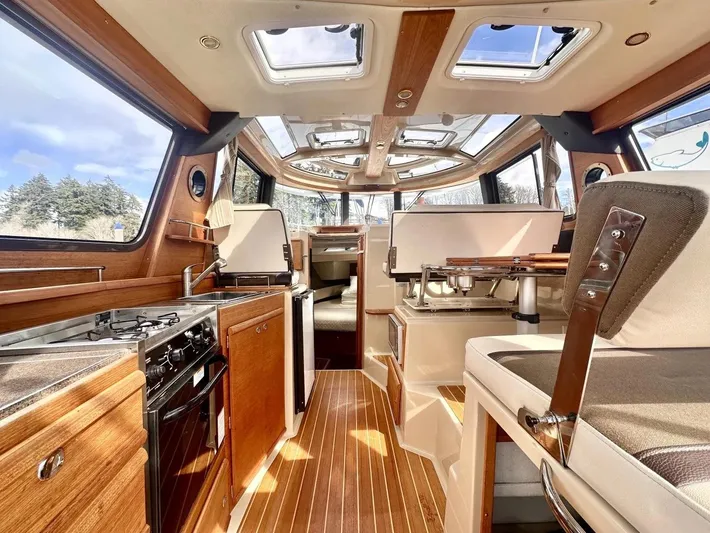  Yacht Photos Pics 2015 Ranger Tugs R-29S interior with wood finish, skylights, and modern kitchen amenities.