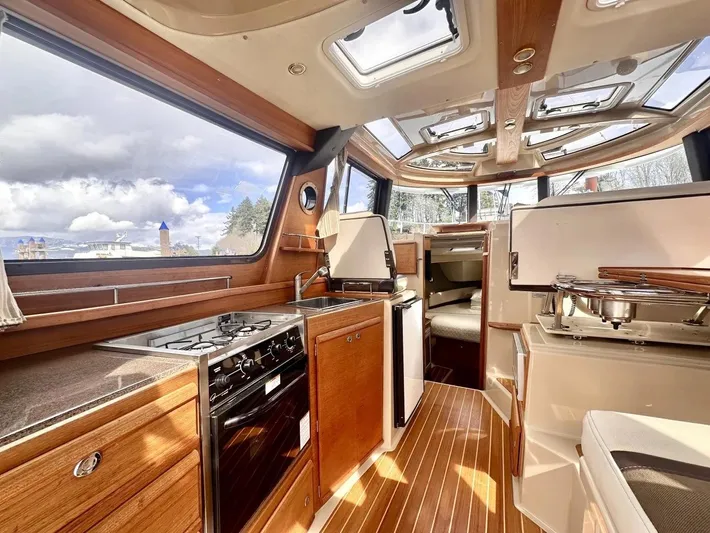  Yacht Photos Pics Interior of 2015 Ranger Tugs R-29S boat with modern kitchen and wood finishes.