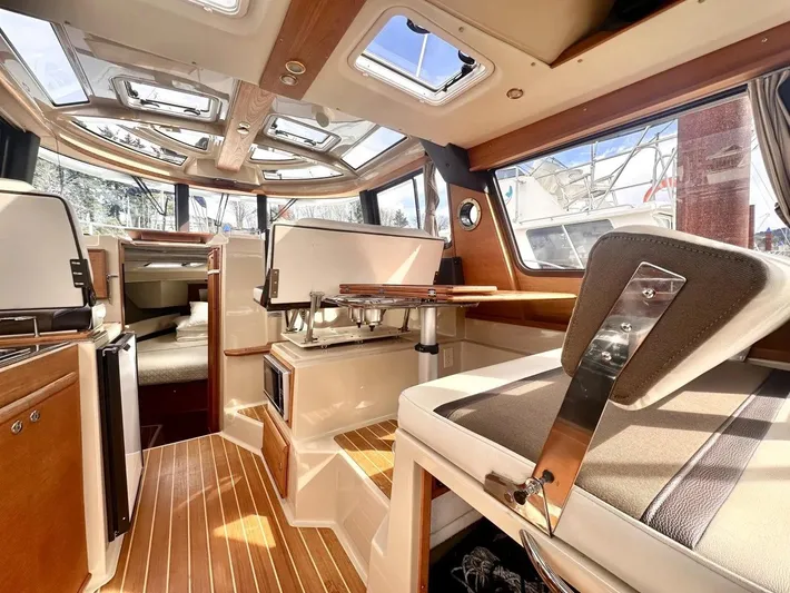  Yacht Photos Pics Interior of 2015 Ranger Tugs R-29S boat with wood accents and panoramic windows.