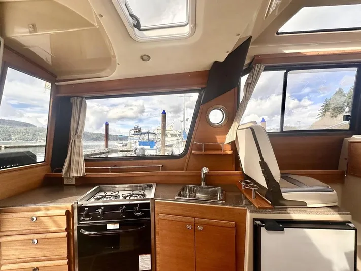  Yacht Photos Pics Interior of 2015 Ranger Tugs R-29S with kitchen and scenic window view.