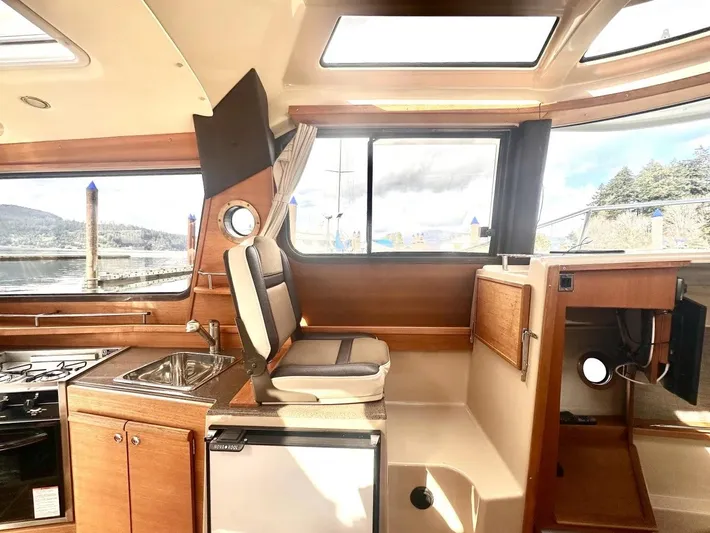  Yacht Photos Pics Interior of 2015 Ranger Tugs R-29S with kitchen and seating area.